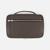 A brown rectangular Leather Travel Bag by BRUNELLO CUCINELLI, featuring a top handle and a front zippered pocket, is photographed against a white background. This luxury toiletry case is an indispensable men's travel accessory, expertly blending style and functionality for all your journeys.