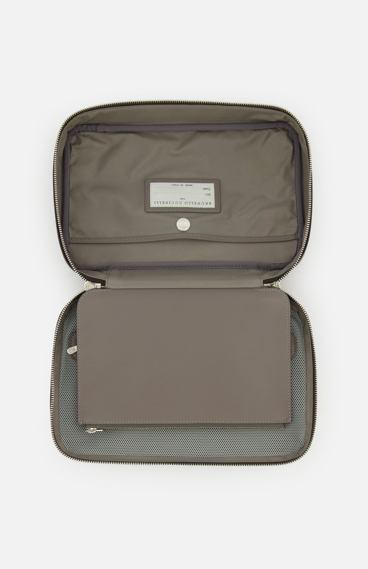 Open leather travel bag by BRUNELLO CUCINELLI in gray, featuring a zip closure, inner flap, fabric lining, snap button, and a visible label on the interior pocket—crafted as an elegant men's accessory inspired by the classic toiletry bag.