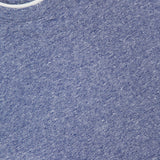 Close-up of BRUNELLO CUCINELLI Linen Cotton Double Layered T-Shirt in blue, featuring a crew neck with white collar trim and an inside label reading "BRUNELLO CUCINELLI Made in Italy" beneath a crest.