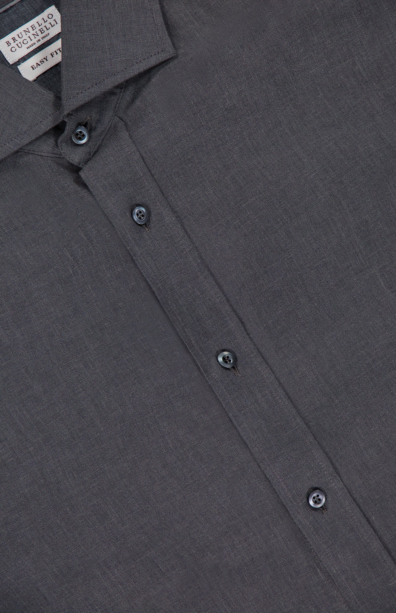 A close-up of the BRUNELLO CUCINELLI Linen Long Sleeve Shirt in dark grey shows its textured fabric, collar, buttons, and branded tag. This elegant men's shirt is expertly crafted in Italy.