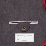A close-up shows the inside pocket of the BRUNELLO CUCINELLI Linen Single-breasted Suit Jacket, with a button flap, red lining, and a label featuring spaces for name and date plus “Made in Italy” text.