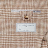 Close-up of the interior of the Plaid Wool-blend Sportcoat, featuring a white BRUNELLO CUCINELLI label and a neatly tailored small pocket above it, secured with a single tan button—an exquisite detail that highlights the exceptional craftsmanship of this luxury piece.