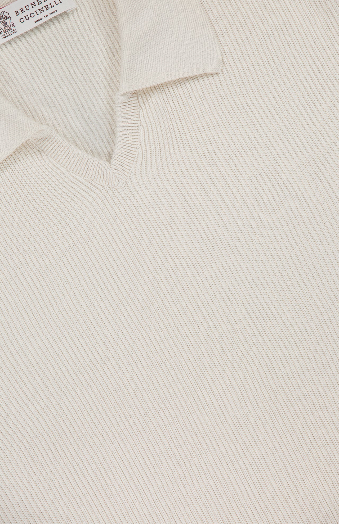 A close-up of the BRUNELLO CUCINELLI Polo Short Sleeve Sweater in white, crafted in an English rib knit.
