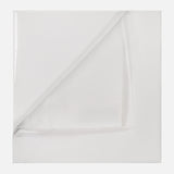 A neatly folded BRUNELLO CUCINELLI Sea Island Cotton Twill Pocket Square is displayed on a flat white surface, with one corner partially turned to reveal the underside.