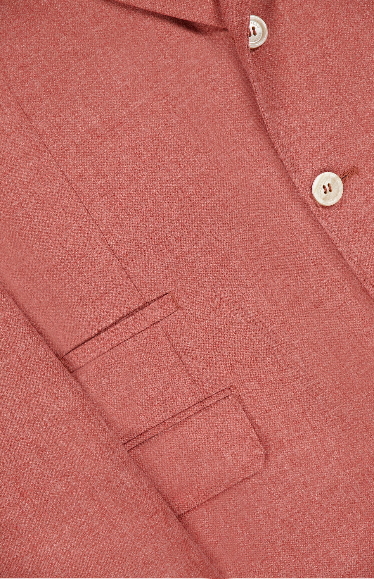 Close-up of BRUNELLO CUCINELLI's Virgin Wool, Cotton and Silk Sportcoat in dusty pink, made in Italy with white buttons, a notched lapel, and two welt pockets.