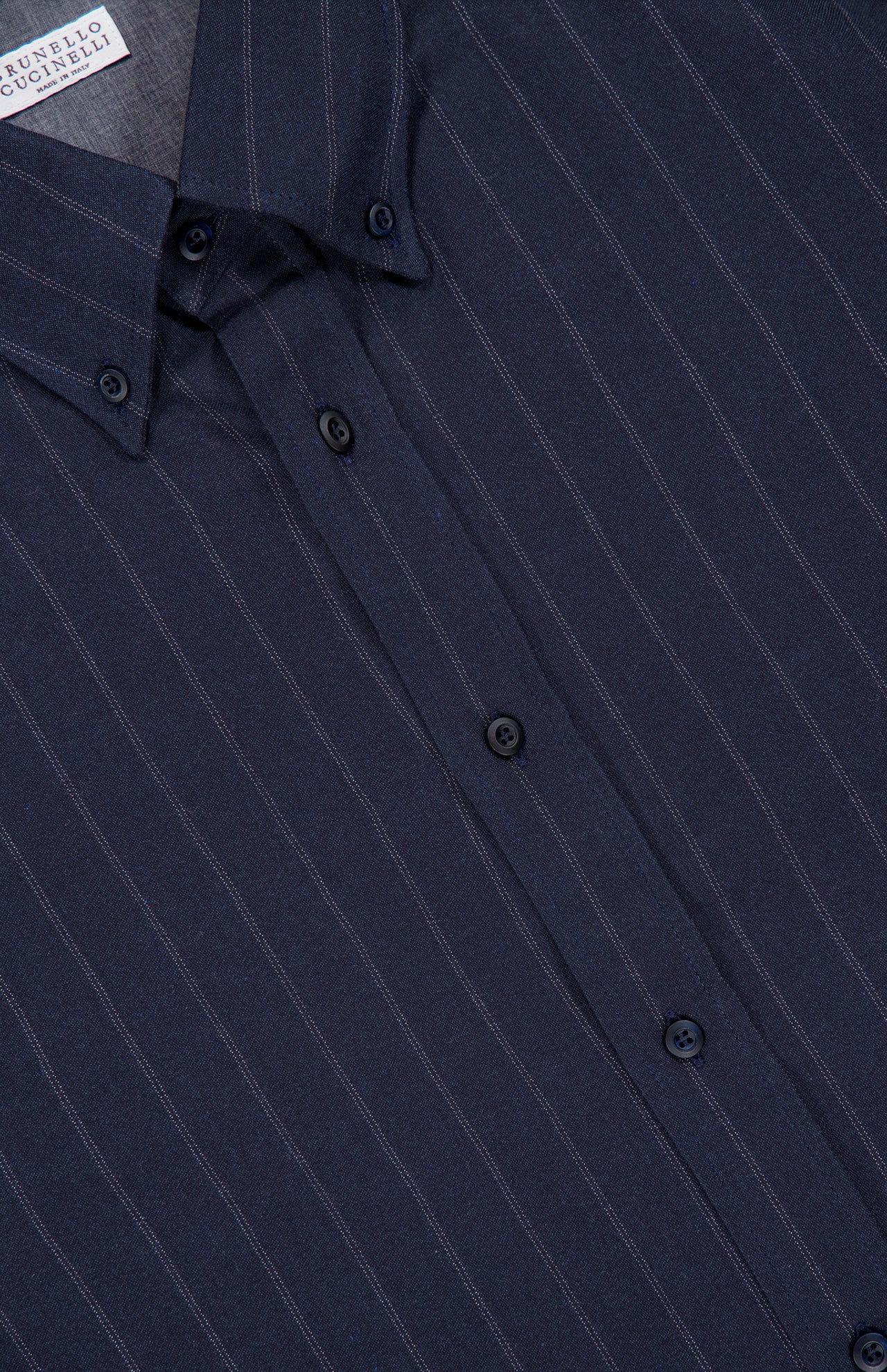 Brunello Cucinelli Striped Long Sleeve Button Up Shirt in dark navy blue with thin white vertical pinstripes and a button-down collar.