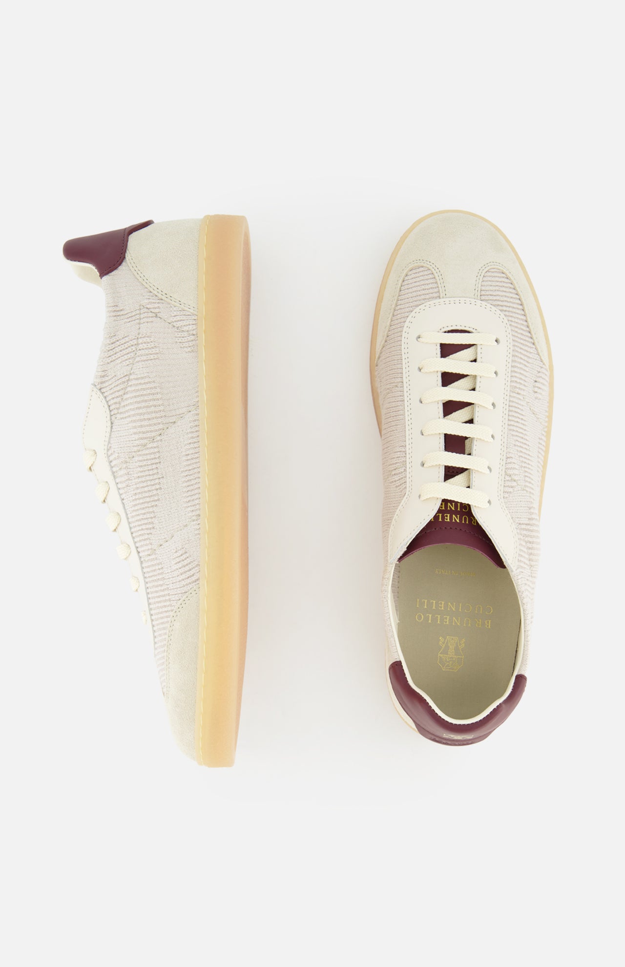 The Suede Leather Detailing Sneakers by BRUNELLO CUCINELLI feature beige washed suede, a subtle plaid pattern, white laces, gum soles, and maroon accents on the heel and tongue. Shown from side and top views against a white background.