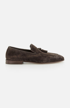 The BRUNELLO CUCINELLI Suede Tassel Loafer, made in Italy from dark brown suede with a low heel, decorative stitching, and front tassel detail, is shown on a plain white background.