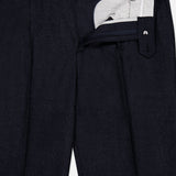 The Wool Suit Trouser Pant by BRUNELLO CUCINELLI showcases a dark navy shade with neat pleats, a structured waistband, and refined button closure—partially unzipped to reveal its inner lining and precise button accents. Expertly crafted from subtly textured virgin wool, these trousers are completed with sharp, visible creases for an impeccably polished appearance.