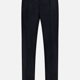 The BRUNELLO CUCINELLI Wool Suit Trouser Pant, featuring a dark navy hue, button closure, belt loops, front pleats, and cuffed hems, is displayed against a white background.