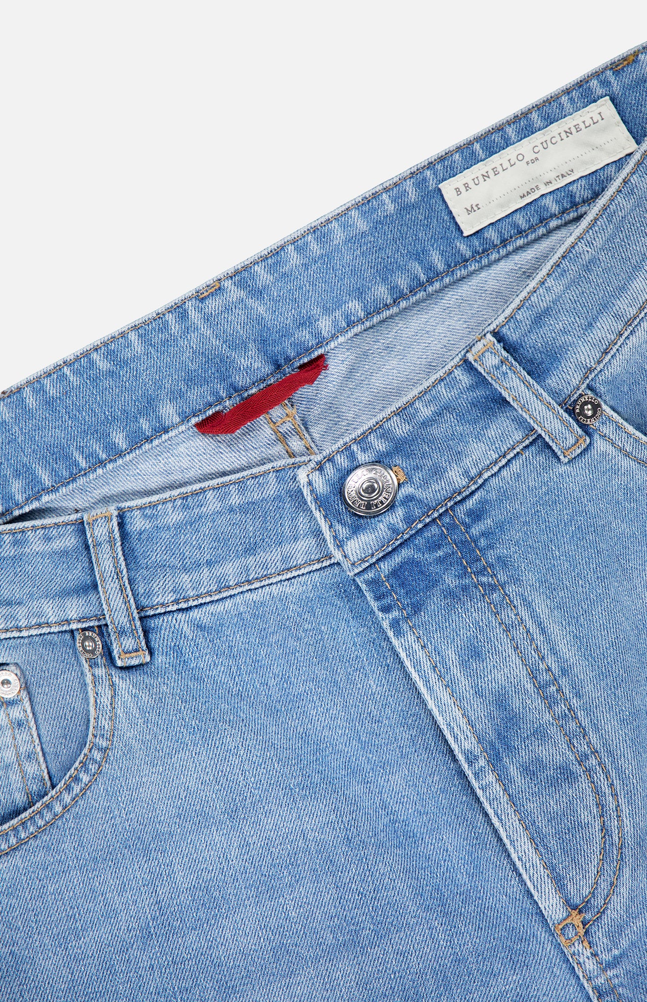 Close-up of light blue BRUNELLO CUCINELLI Traditional Fit Button Fly Jeans, highlighting the waistband, belt loops, button, front pockets, and a white label with brand name and size.