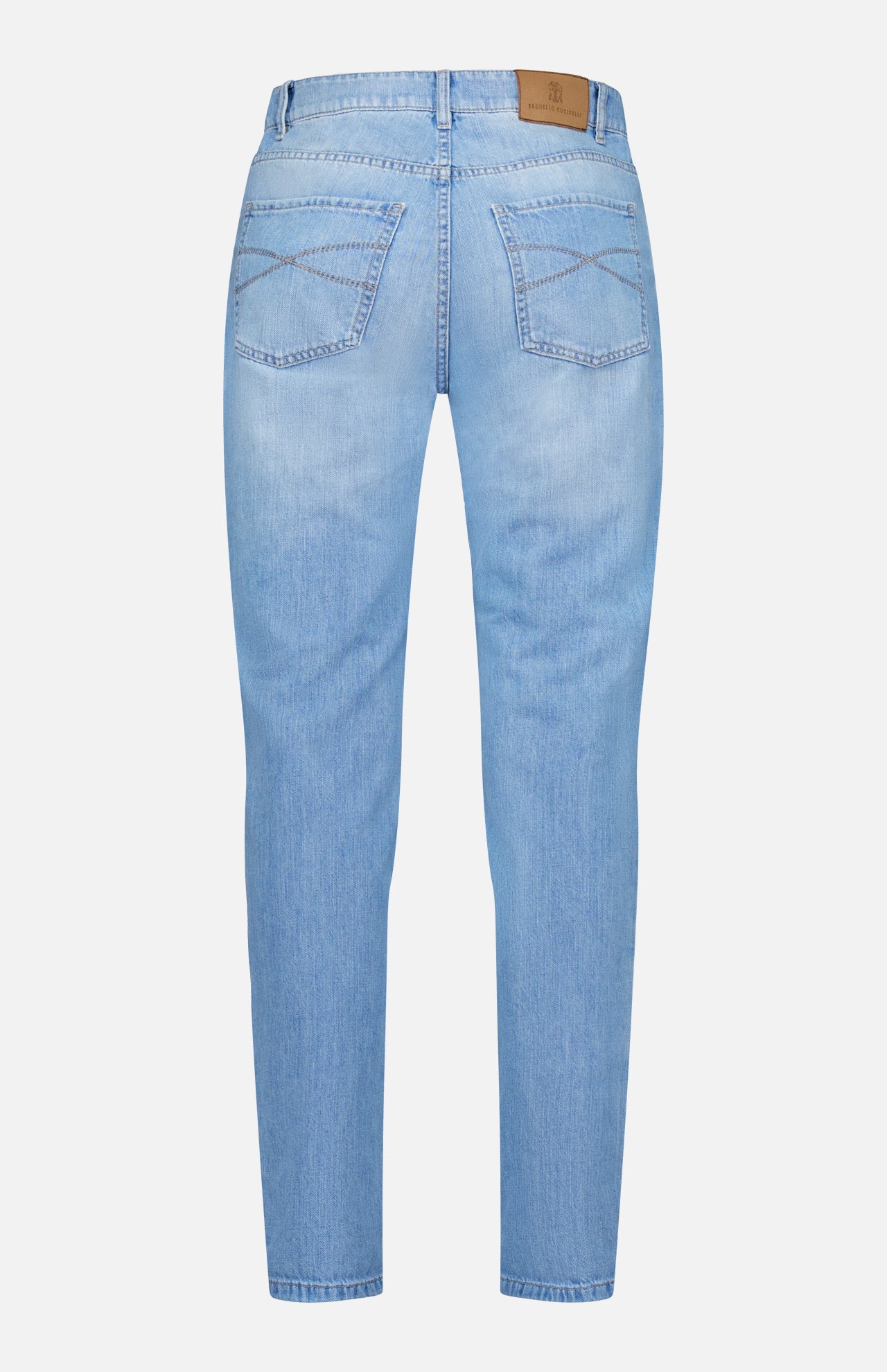 Back view of BRUNELLO CUCINELLI Traditional Fit Light Denim, featuring blue lightwash denim with two rear pockets, subtle stitching details, belt loops, and a brown leather patch on the waistband. These jeans offer a straight-leg fit with no visible distressing.
