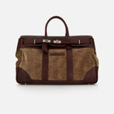 The BRUNELLO CUCINELLI Travel Duffle Bag with Chevron-effect, crafted in large brown leather and tan fabric with silver hardware and a top handle, features a structured rectangular silhouette. Vintage-inspired details exude timeless elegance, beautifully showcased against a plain white background.