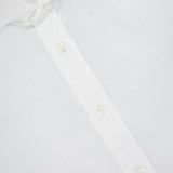 Close-up of a Brunello Cucinelli Twill Melange Dress Shirt featuring a pointed collar, three visible buttons, and an Easy Fit label. The cotton-linen blend fabric appears smooth and slightly textured for timeless menswear style.