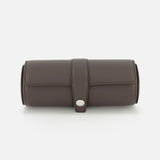 The BRUNELLO CUCINELLI Leather Watch Case is a cylindrical dark brown leather holder featuring a flap closure with a silver button, making it an elegant addition to your travel accessories. Shown against a white background.