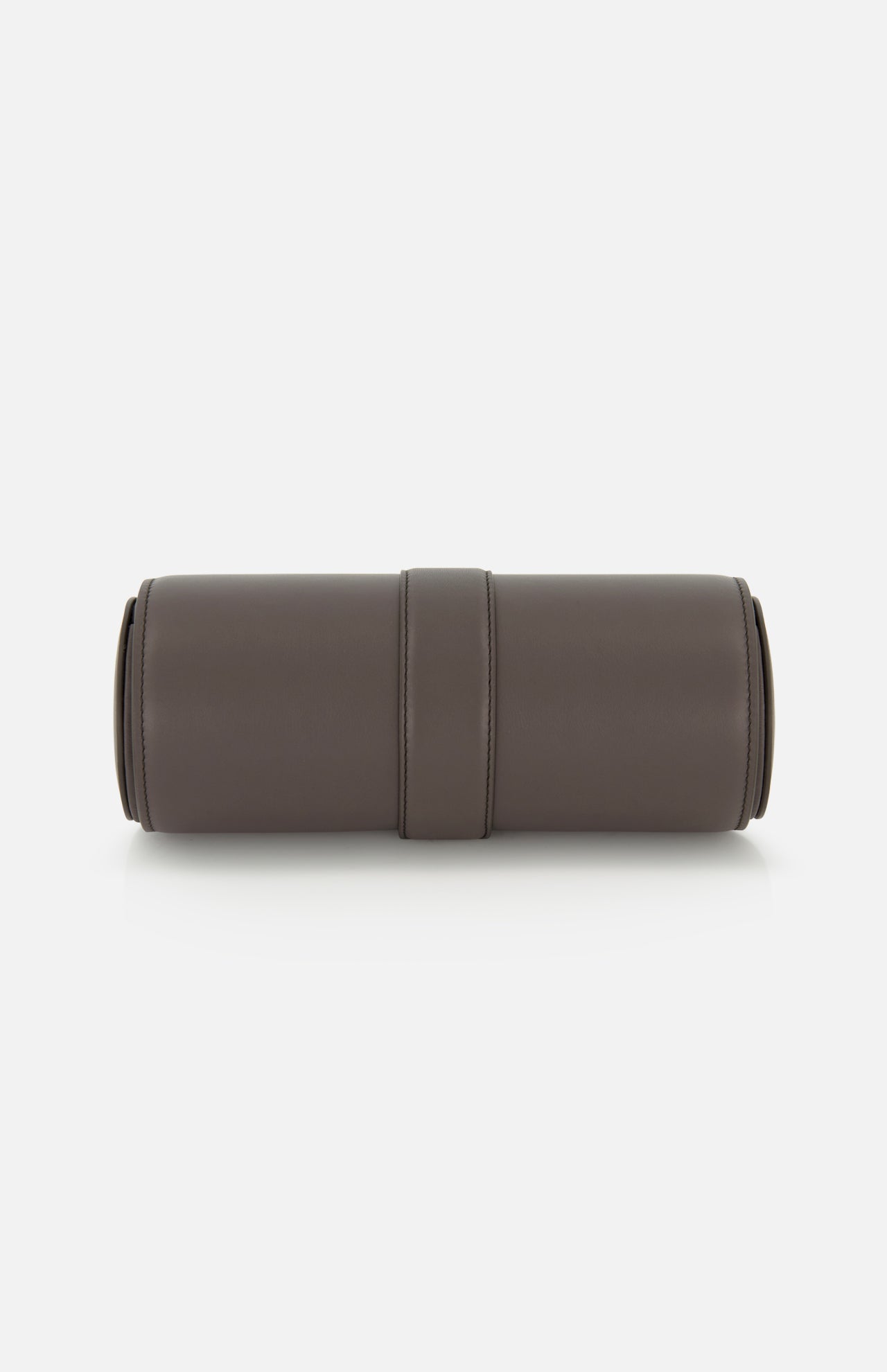 A cylindrical, brown BRUNELLO CUCINELLI Leather Watch Case—ideal as a leather watch holder or sophisticated travel accessory—is displayed lying horizontally on a white background. The case boasts a smooth texture and minimalistic design, accented by a central seam.