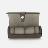 The BRUNELLO CUCINELLI Leather Watch Case features gray suede and dark brown leather with a secure snap closure. Opened, it reveals a cushion designed to hold multiple watches, making this elegant accessory an essential addition to your travel collection. Shown against a white background.