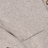 Close-up of the Water Resistant Cashmere Sport Jacket by BRUNELLO CUCINELLI, featuring a beige and white pinstripe pattern. This Italian-made blazer showcases a front pocket and four brown buttons on the sleeve, with visible fabric texture and stitching that emphasize the refined craftsmanship characteristic of BRUNELLO CUCINELLI’s cashmere sport jackets.