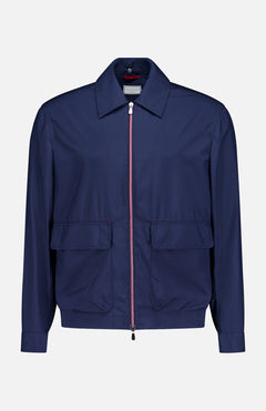 The BRUNELLO CUCINELLI Water Resistant Contrast Zip Jacket is a lightweight men’s navy jacket featuring a classic collar, front zipper, two large front flap pockets, and long sleeves, shown against a plain white background.