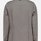 A back view of the BRUNELLO CUCINELLI Water Resistant Safari Jacket in gray, highlighting its brown faux fur detachable shearling collar, buttoned cuffs, shoulder epaulets, and visible stitching details. The jacket is crafted from a durable canvas-like fabric for added versatility.