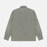 The BRUNELLO CUCINELLI Western Cotton Long Sleeve Shirt is shown from the back in light gray, featuring a collar and buttoned cuffs. Crafted from soft garment-dyed gabardine, it is displayed on a white background.