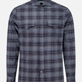 The BRUNELLO CUCINELLI Western Cotton Plaid Shirt is a men’s long-sleeve button-up featuring a blue and gray plaid pattern, two chest pockets with flaps, and a classic collar, displayed on a plain white background.