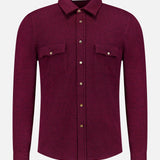 A maroon Snap-front Western Overshirt by BRUNELLO CUCINELLI, featuring long sleeves, a classic collar, and brown snap buttons down the front. The luxury Italian design includes two chest pockets, each secured with a snap button. Photographed against a plain white background.