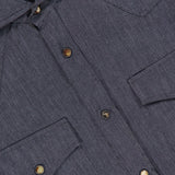 Close-up of the BRUNELLO CUCINELLI Western Snap-front Shirt in gray, featuring metal snap closures, two chest pockets with flaps, and a Buffalo Collection label visible inside the collar. The subtly textured fabric provides a refined look and feel reminiscent of cotton cashmere.