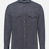 The BRUNELLO CUCINELLI Western Snap-front Shirt is a long-sleeve, button-up shirt crafted from dark blue denim, featuring two chest pockets with pointed flaps, and is displayed against a plain white background.