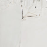 A close-up of BRUNELLO CUCINELLI Piece-Dyed Cotton Pull-On Jeans with an elastic waistband, partially unzipped fly, and visible interior tags, laid flat on a white background.