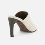 A back view of the BRUNELLO CUCINELLI Suede Curved Monili 80MM Mule Heel in beige, featuring monili embroidery, a textured dark high heel, and an open back, displayed against a white background.