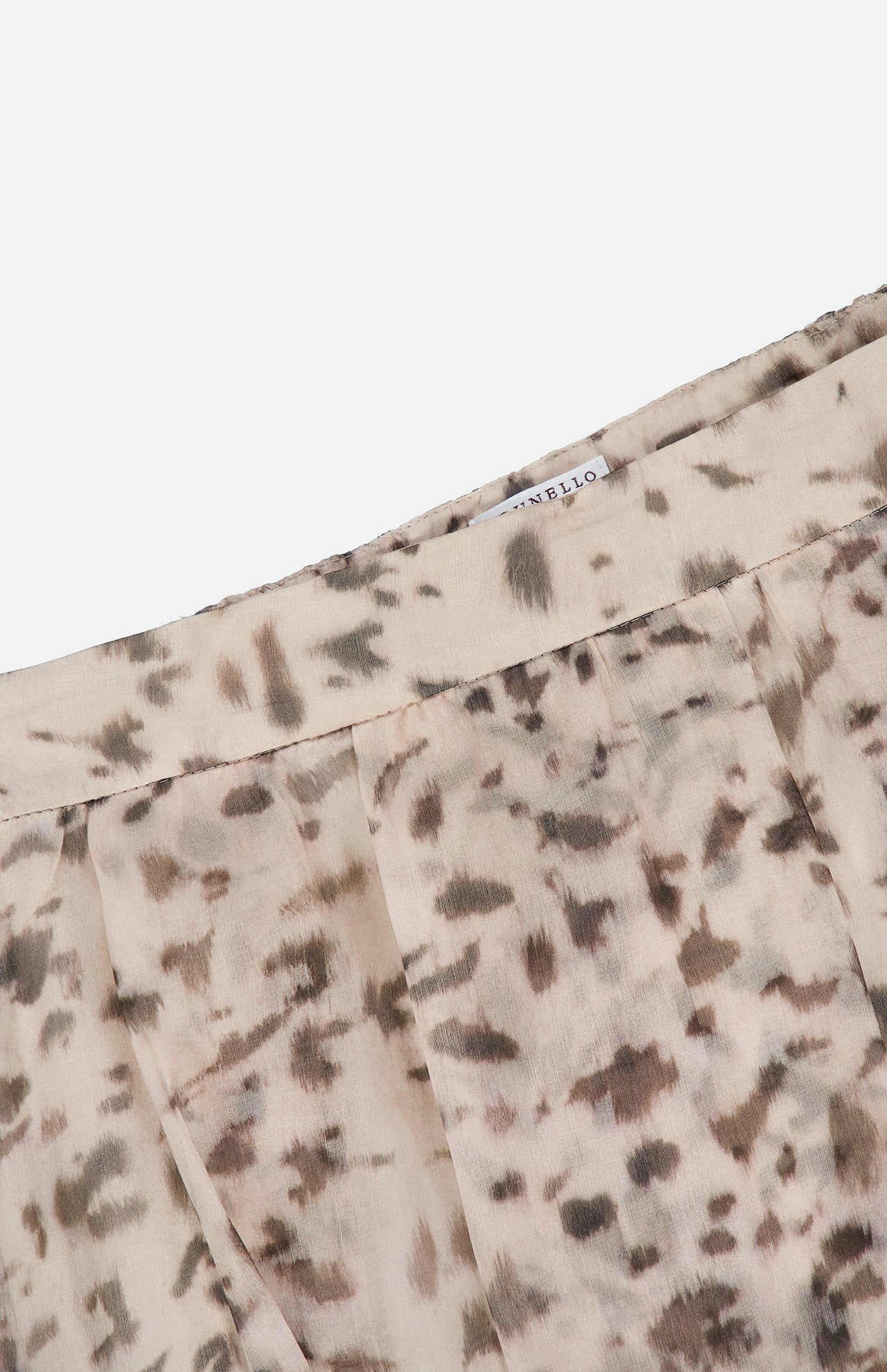 Close-up of the BRUNELLO CUCINELLI Artemis Animalier Print Silk Pleated Skirt, showcasing its light beige silk fabric adorned with a brown and gray abstract animal print pattern, delicate pleats, and a partially visible white tag at the waistband.