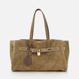 The Explorer Suede Medium Shopper Bag by BRUNELLO CUCINELLI is a medium-sized tan suede shoulder bag, expertly crafted in Italy. It features two handles, a distinctive leather strap detail, and a gold padlock accent on the front, all showcased against a plain white background.
