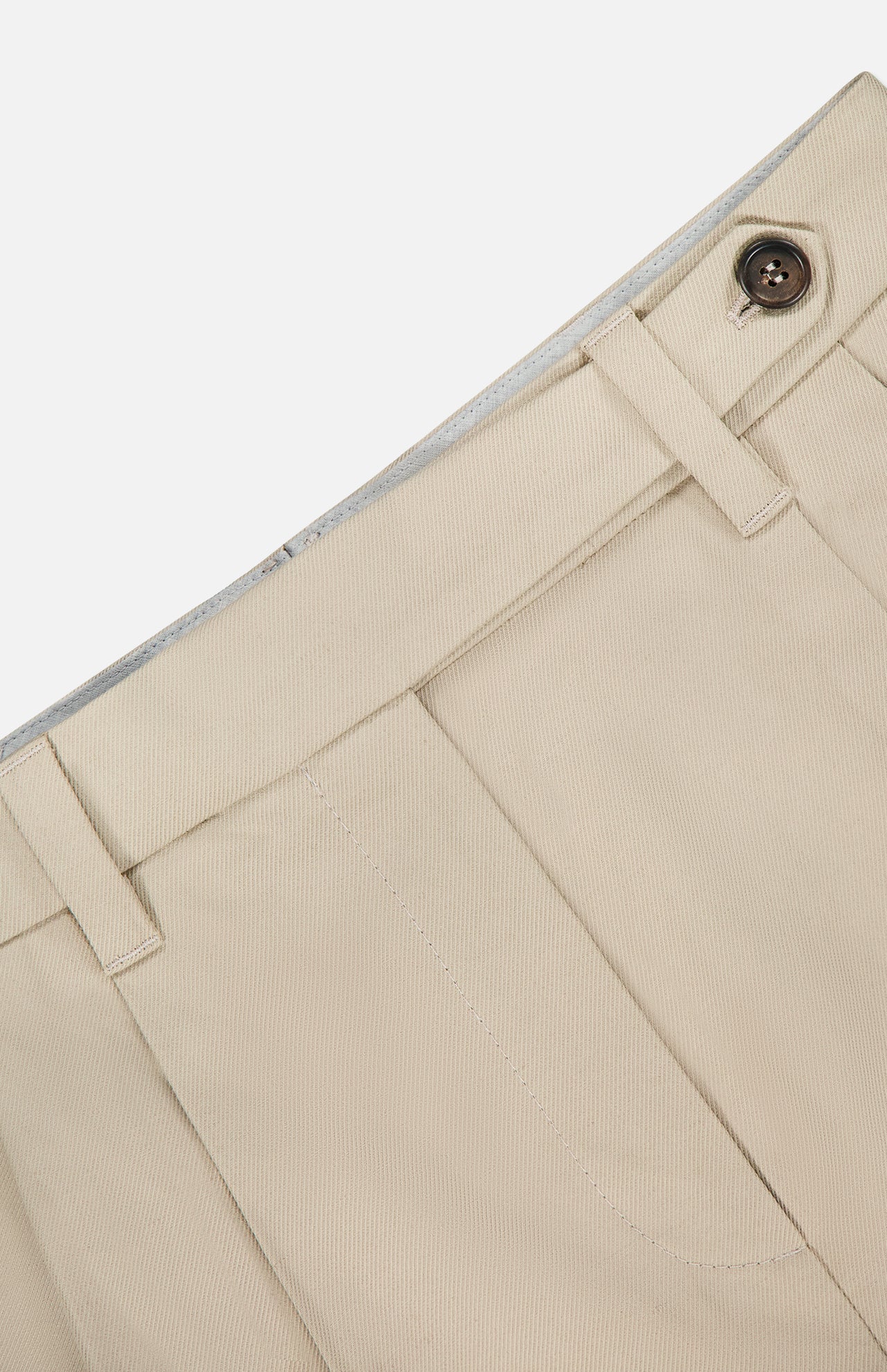 Close-up of the waist and upper section of BRUNELLO CUCINELLI Cotton Linen Bull Bermuda Pleated Short, highlighting the waistband with belt loops, button closure, pleats, and a partial pocket against a plain background.