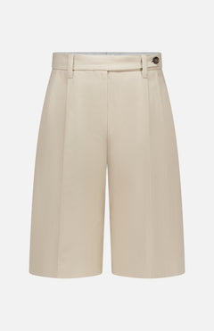 The BRUNELLO CUCINELLI Cotton Linen Bull Bermuda Pleated Short features front pleats, belt loops, and a button detail at the waistband, shown in beige on a plain white background.