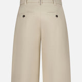 Back view of BRUNELLO CUCINELLI Cotton Linen Bull Bermuda Pleated Short in beige, featuring belt loops, two buttoned welt pockets, and a fitted waistband against a plain white background.