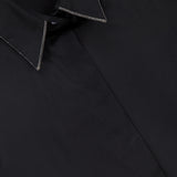 Close-up of a BRUNELLO CUCINELLI Cotton Poplin Sleeveless Top, showcasing fine stitching and monili trim on the collar. The inside collar label displays the BRUNELLO CUCINELLI brand name.