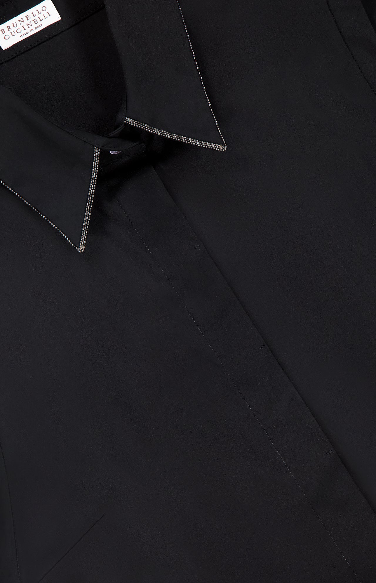 Close-up of a BRUNELLO CUCINELLI Cotton Poplin Sleeveless Top, showcasing fine stitching and monili trim on the collar. The inside collar label displays the BRUNELLO CUCINELLI brand name.