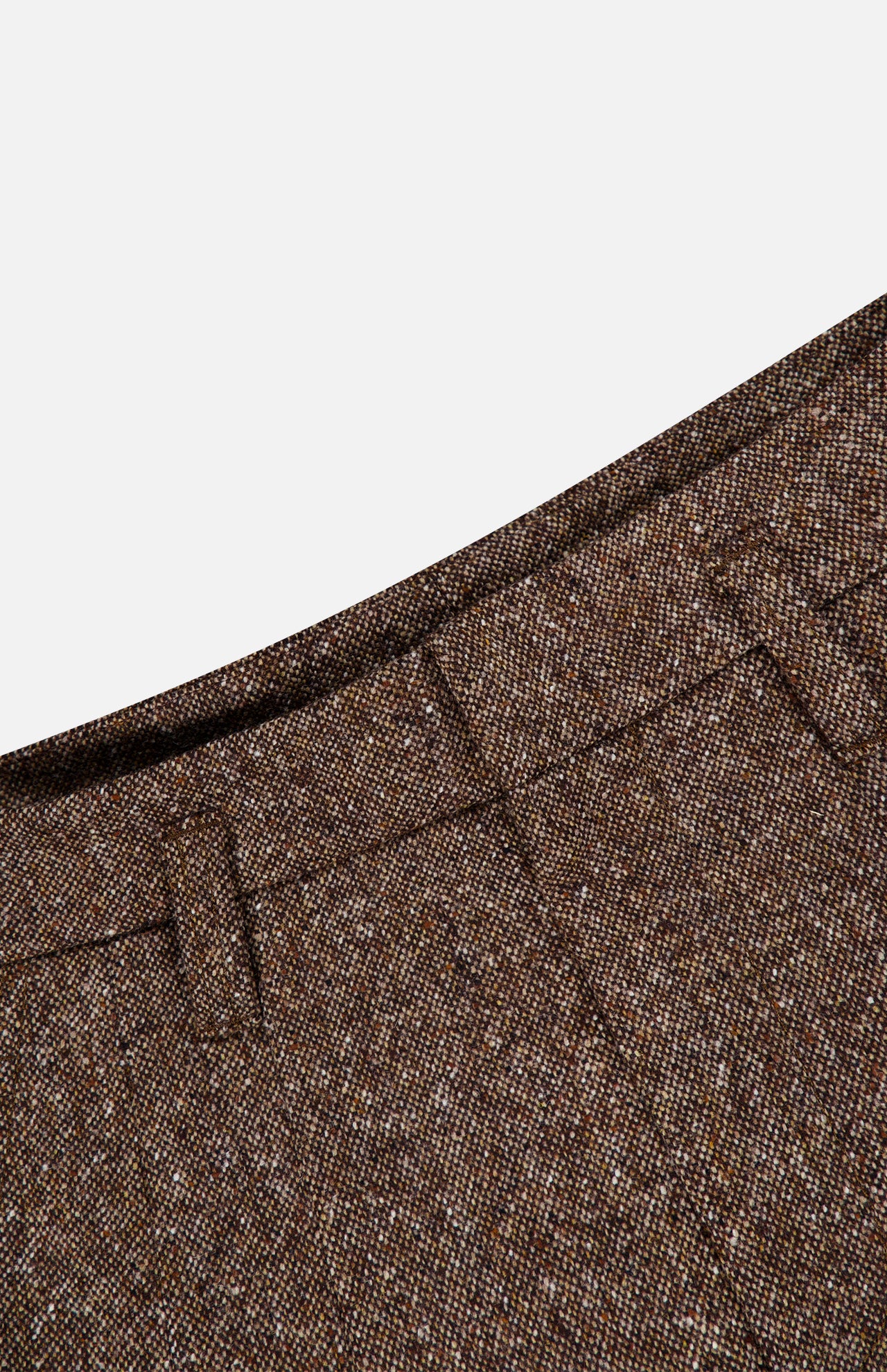Close-up of the waistband of the BRUNELLO CUCINELLI Donegal Wool Barrel Pleated Pant, featuring prominent belt loops and highlighting the rich texture and weave of the brown tweed wool fabric in a classic barrel fit silhouette, set against a plain white background in signature Brunello Cucinelli style.