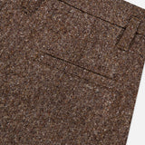 Close-up of the BRUNELLO CUCINELLI Donegal Wool Barrel Pleated Pant, featuring a classic barrel fit in brown tweed wool with a waistband adorned with belt loops and a small front pocket, displayed against a white background.