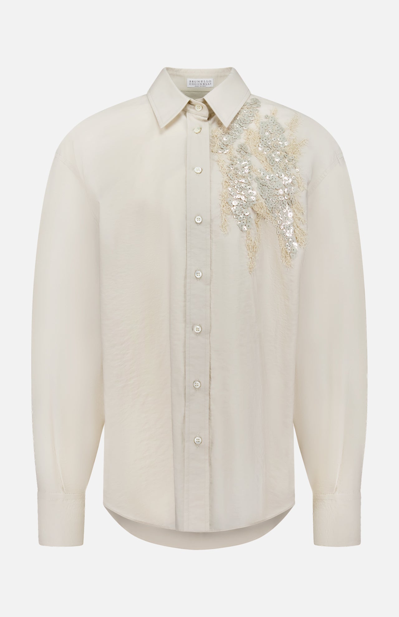 The BRUNELLO CUCINELLI Halo Effect Embroidery Cotton Poplin Shirt is a long-sleeved, quartz-colored blouse featuring a collar and silver sequin and bead floral embellishments on the left shoulder.