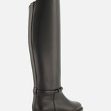 A single BRUNELLO CUCINELLI Leather Monili Band Tall Riding Boot, featuring black leather, a knee-high silhouette with a low heel, rounded toe, and minimal detailing, is displayed in a three-quarter rear view against a plain white background.