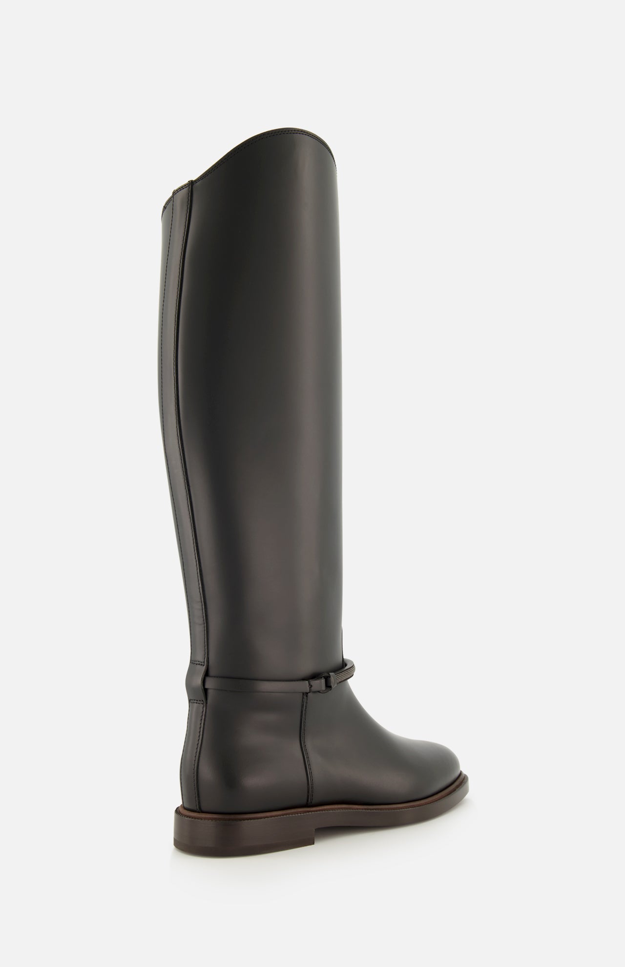 A single BRUNELLO CUCINELLI Leather Monili Band Tall Riding Boot, featuring black leather, a knee-high silhouette with a low heel, rounded toe, and minimal detailing, is displayed in a three-quarter rear view against a plain white background.