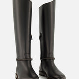 A pair of BRUNELLO CUCINELLI Leather Monili Band Tall Riding Boots in sleek black leather feature a rounded toe and subtle strap detailing at the ankle, set against a plain white background—ideal for those seeking classic knee-high equestrian boots with timeless sophistication.
