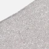 Close-up of a light silver Linen Mohair Diamante Knit Pencil Skirt from BRUNELLO CUCINELLI, densely adorned with shiny sequins for a sparkling, textured effect—an elegant choice for your next cocktail party. The fabric curves gently at the top left.