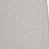 Close-up of BRUNELLO CUCINELLI's Linen Mohair Diamante Knit Pencil Skirt, showing its light grey, sparkly texture and subtle glittery finish—a chic choice for cocktail parties. Flat rectangular section with a slightly uneven top edge shown.