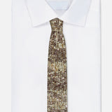 A neatly folded white dress shirt with a BRUNELLO CUCINELLI Mohair Sparkling Diamante Tie, featuring a gold and brown pattern, displayed on a plain white background.