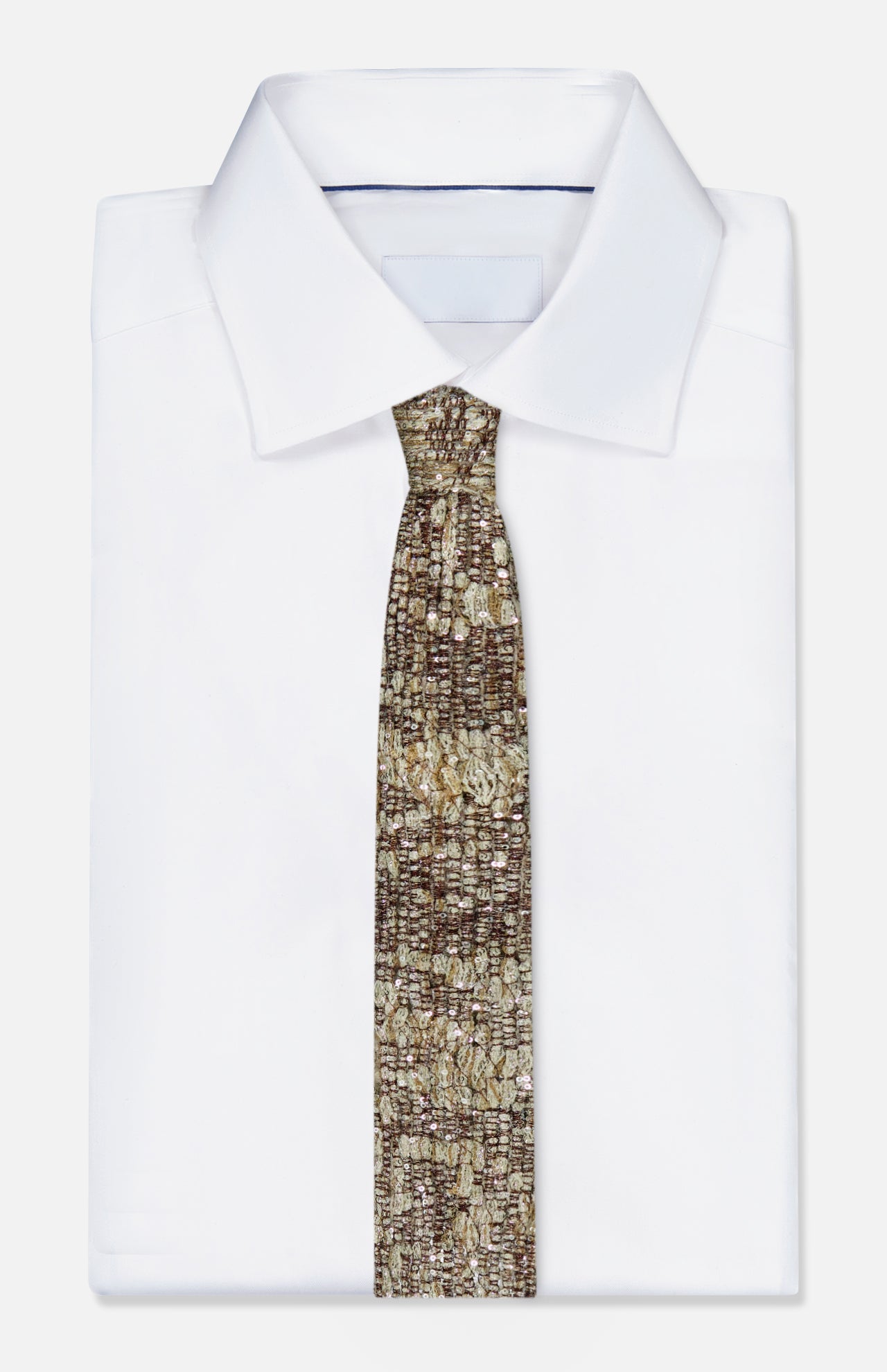 A neatly folded white dress shirt with a BRUNELLO CUCINELLI Mohair Sparkling Diamante Tie, featuring a gold and brown pattern, displayed on a plain white background.