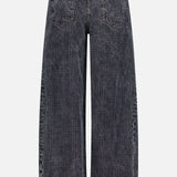 Back view of the BRUNELLO CUCINELLI Prince Of Whales Embossed Wide Barrel Jean, featuring a wide-leg, high-waisted silhouette in grey with a faded texture, two back pockets, visible stitching, and a brown leather patch on the waistband.