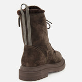 The BRUNELLO CUCINELLI Shearling Lined Lace Boot with Monili Tabs is crafted from luxurious dark chocolate brown suede, featuring a thick sole, lace-up front, and distinctive striped Monili pull tabs at the back. The pair is showcased from an angled rear view against a plain white background.